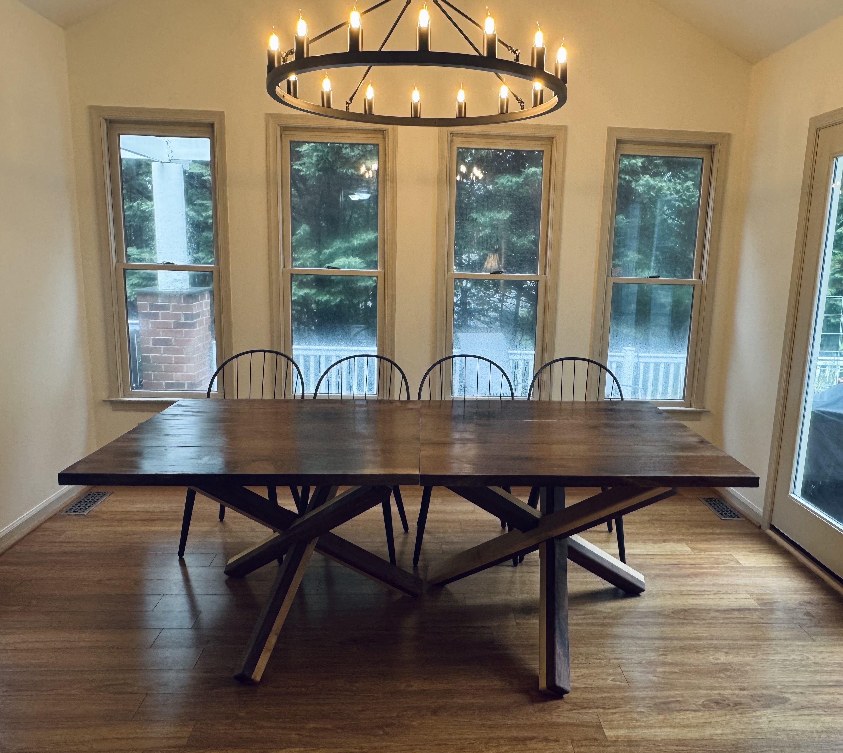 Seven-foot walnut dining table with a double tripod base of walnut and maple